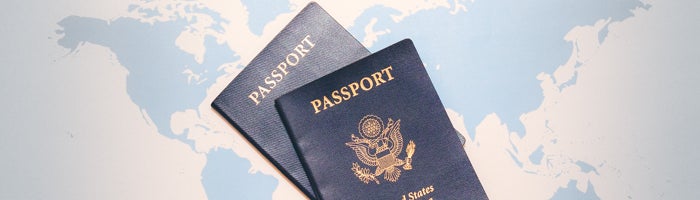 Two U.S. passports displayed on a world map